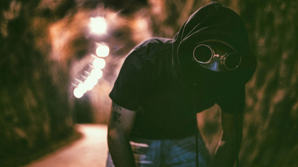 A person with glasses and a hood on