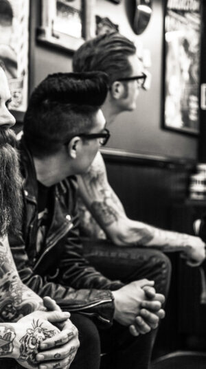 A group of men sitting next to each other.