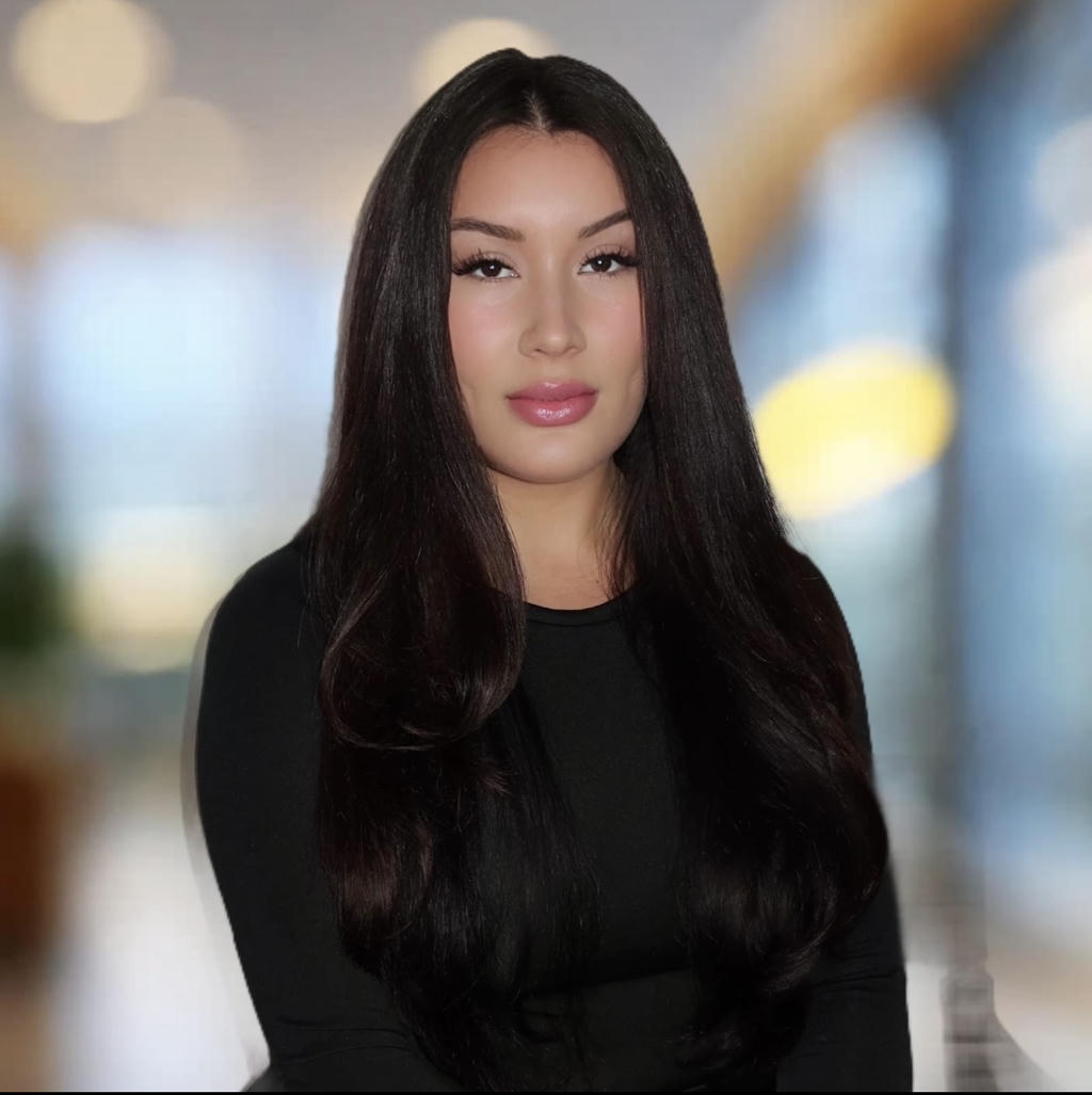 Woman with long hair, blurred background.