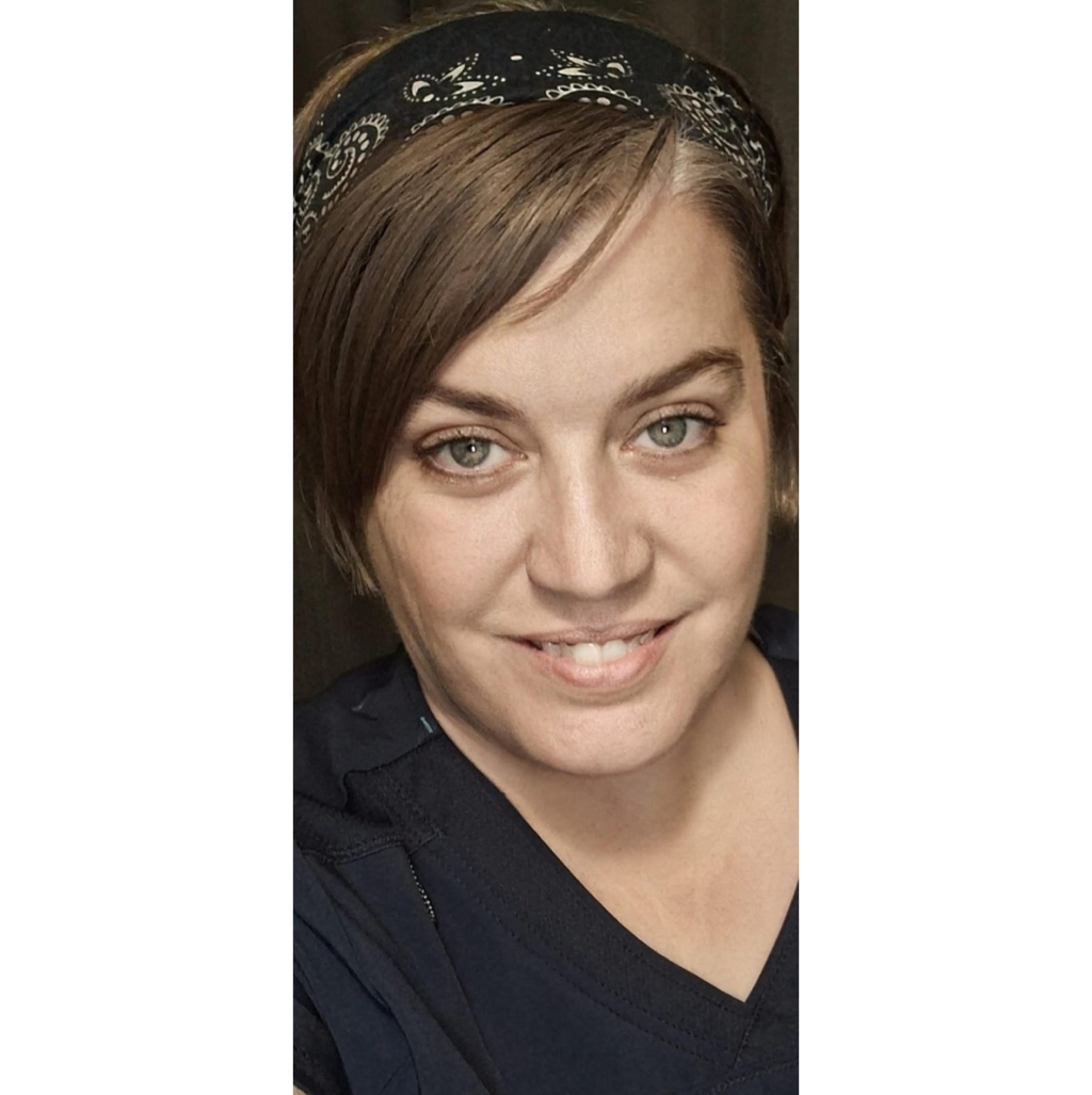 Smiling person wearing a bandana.